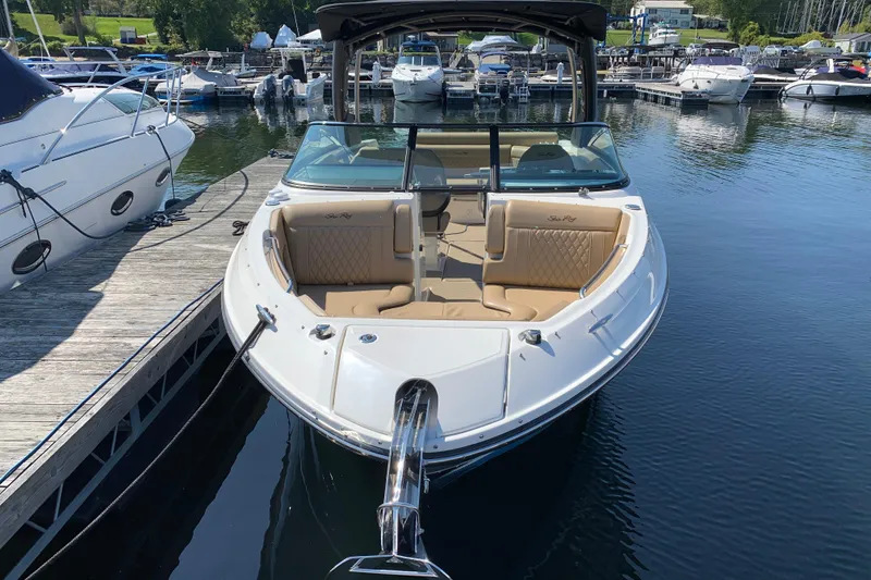 Slide: The Image of 2023 Sea Ray SLX 280 boat docked at marina, featuring luxurious seating and sleek design. - 2
