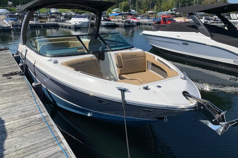 Slide: The Image of 2023 Sea Ray SLX 280 boat docked at marina, featuring sleek design and spacious seating. - 3