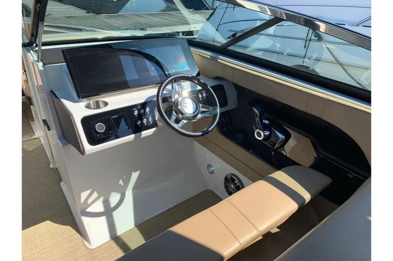 Slide: The Image of 2023 Sea Ray SLX 280 helm with modern steering wheel and control panel. - 6