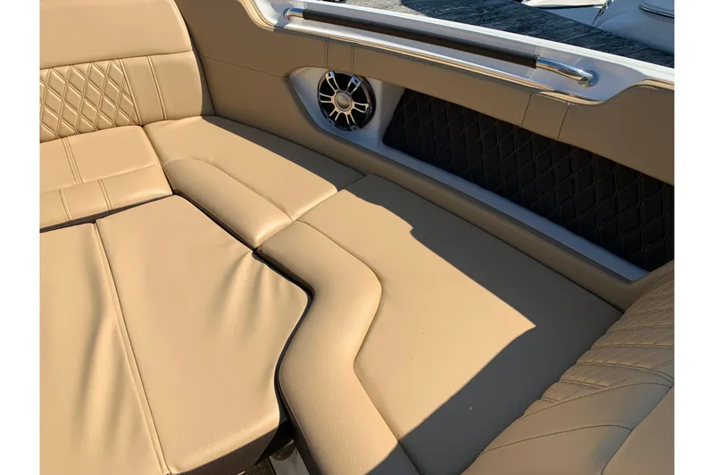 Slide: The Image of Luxurious tan seating on 2023 Sea Ray SLX 280 boat, featuring elegant stitching and speaker detail. - 9