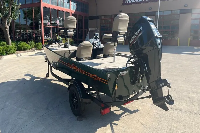 Slide: The Image of 2026 Tracker Bass Tracker Classic Limited boat with Mercury engine, parked outdoors. - 40