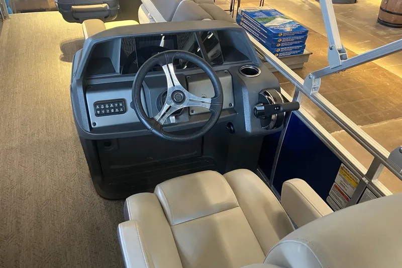 Slide: The Image of 2026 Sun Tracker Fishin' Barge 20 DLX helm with steering wheel and controls. - 4