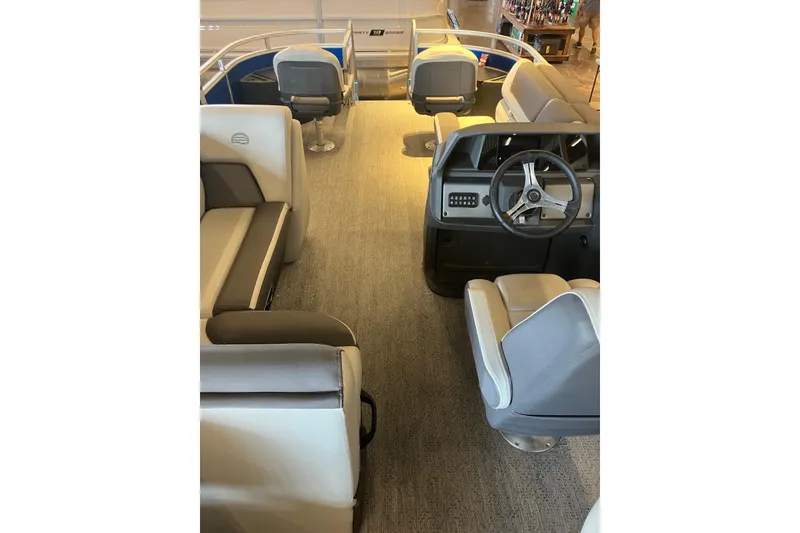Slide: The Image of Interior of 2026 Sun Tracker Fishin' Barge 20 DLX, featuring seating and steering console. - 8