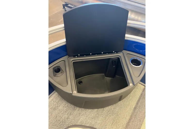 Slide: The Image of 2026 Sun Tracker Fishin' Barge 20 DLX storage compartment with cup holder and utility space. - 2