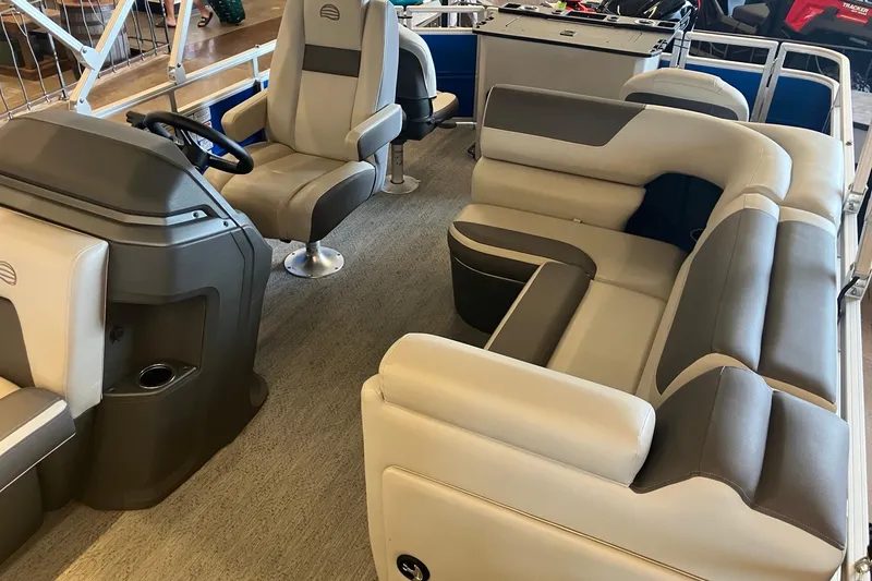 Slide: The Image of Interior of 2026 Sun Tracker Fishin' Barge 20 DLX, featuring comfortable seating and steering console. - 3