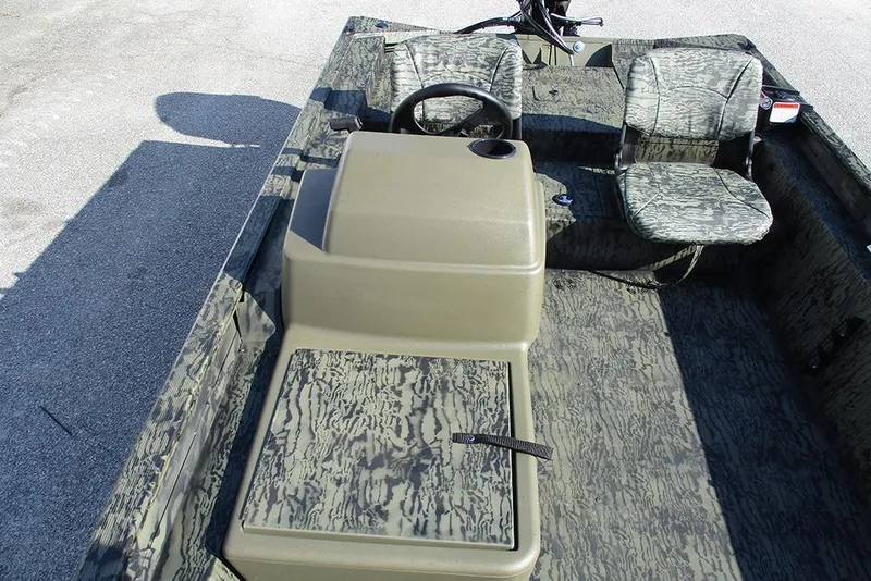 Slide: The Image of 2026 Tracker Grizzly 1754 SC boat interior with camouflage seating and steering console. - 13