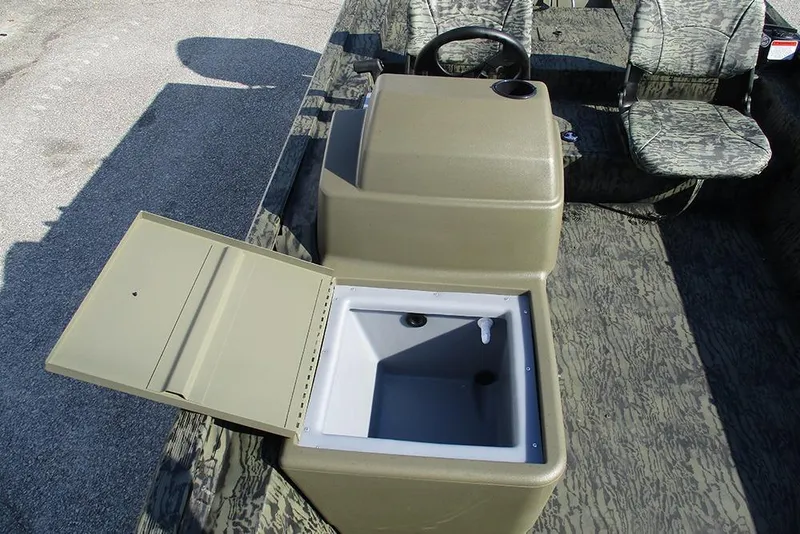 Slide: The Image of 2026 Tracker Grizzly 1754 SC boat interior with open storage compartment and camo seats. - 14