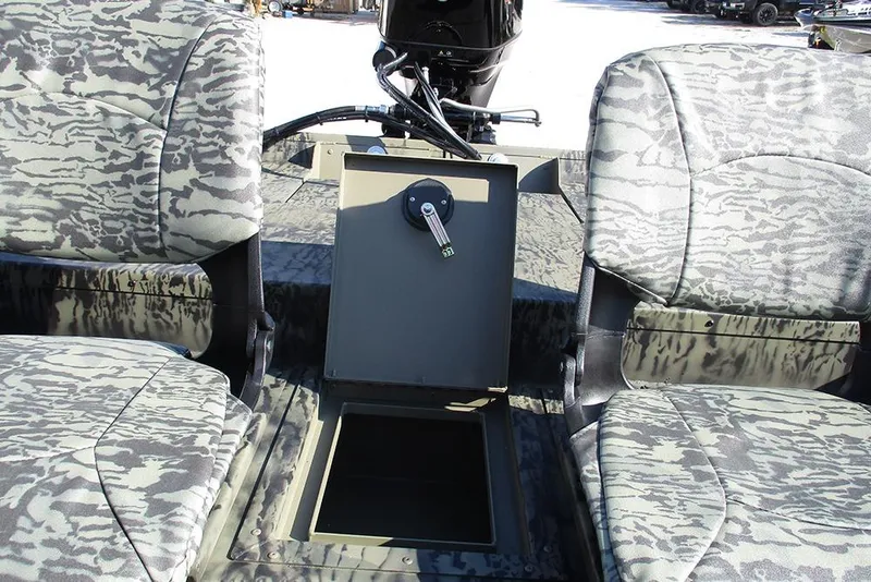 Slide: The Image of 2026 Tracker Grizzly 1754 SC boat interior with camo seats and storage compartment. - 17