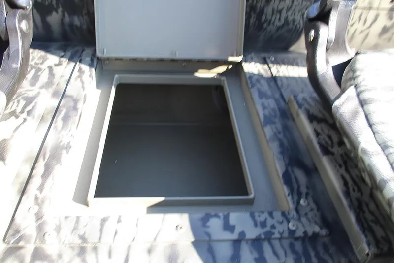 Slide: The Image of 2026 Tracker Grizzly 1754 SC boat storage compartment with open hatch. - 18