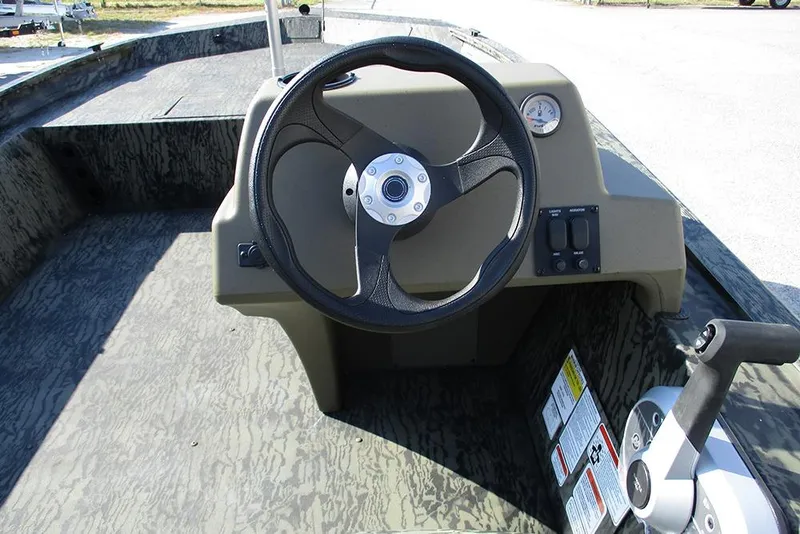 Slide: The Image of 2026 Tracker Grizzly 1754 SC boat console with steering wheel and controls. - 20