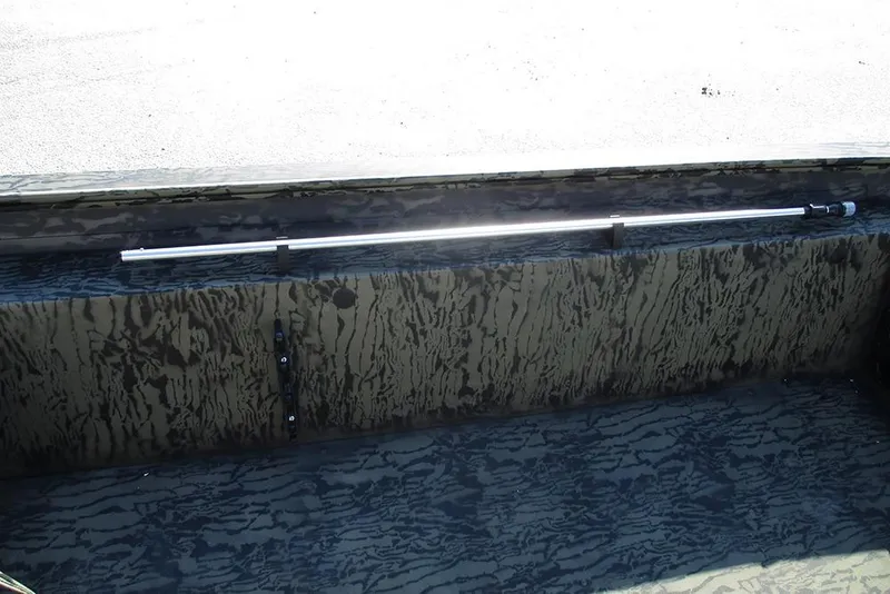 Slide: The Image of 2026 Tracker Grizzly 1754 SC boat interior with camouflage design and mounted fishing rod holder. - 21