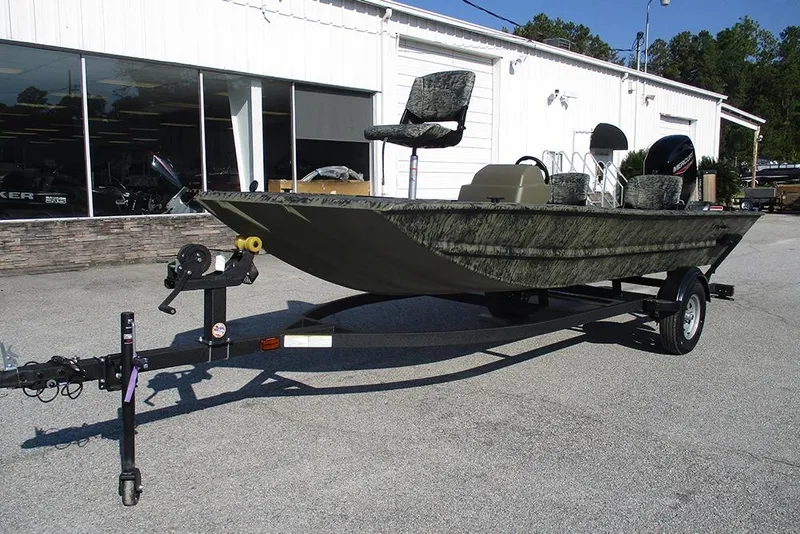 Slide: The Image of 2026 Tracker Grizzly 1754 SC boat on trailer, parked outside a dealership. - 5