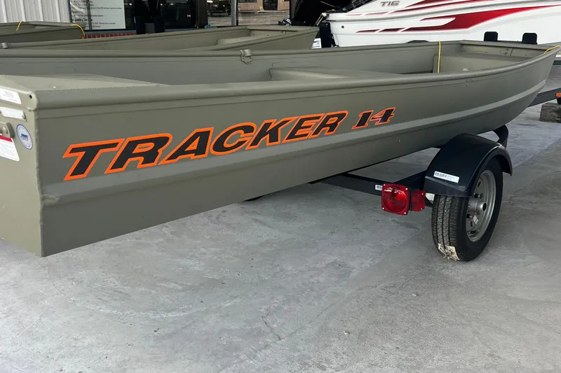 The Image of 2026 Tracker Grizzly 14 Jon boat on trailer, displayed in showroom. - 0