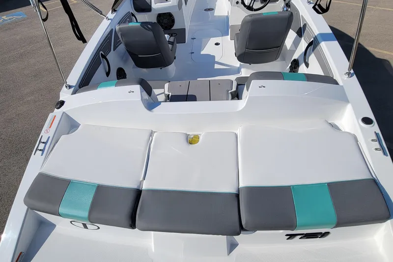 Slide: The Image of 2026 Tahoe T21 boat interior with gray and teal seating, modern design. - 2