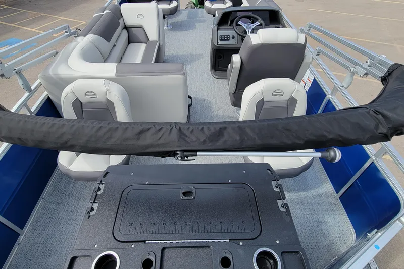 Slide: The Image of 2026 Sun Tracker Fishin' Barge 20 DLX interior with seating and steering console. - 3