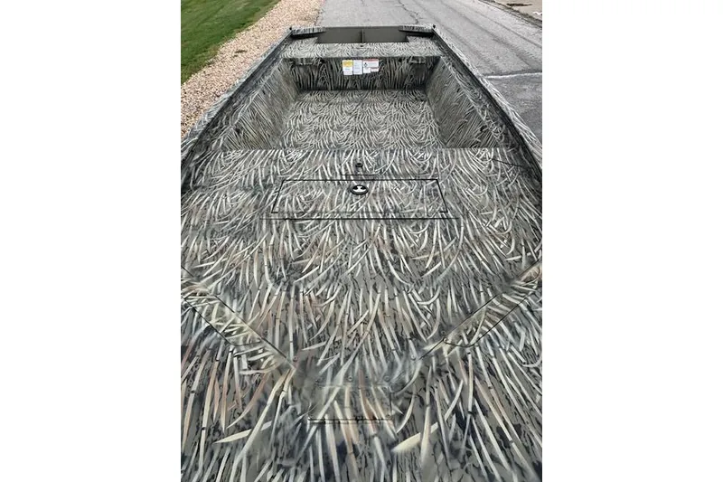 Slide: The Image of 2026 Tracker Grizzly 1648 Utility boat on trailer, front view, parked on concrete. - 2