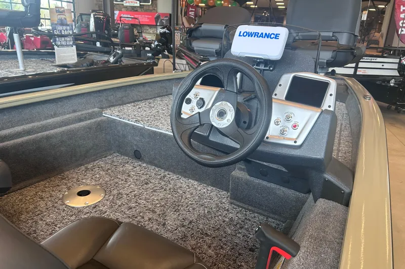 Slide: The Image of 2026 Tracker Pro Team 175 Crappie Edition boat interior with steering wheel and Lowrance electronics. - 6