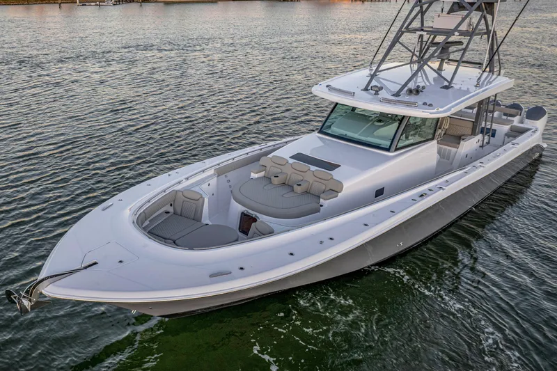 Slide: The Image of 2026 HCB 56 Suenos GIX luxury boat on calm water, showcasing sleek design and spacious deck. - 21