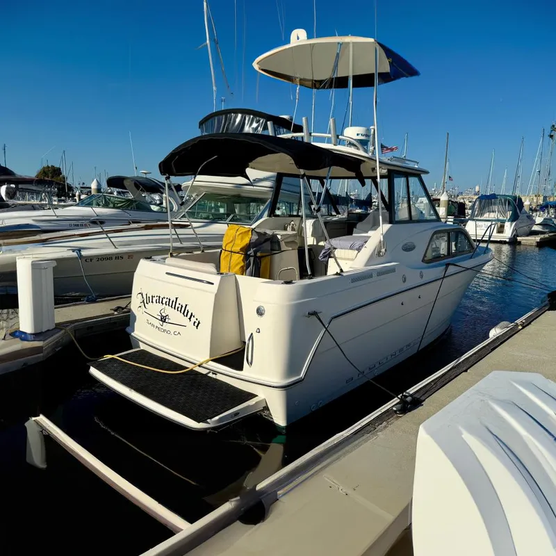The Image of 2002 Bayliner 2452 Ciera Classic boat docked at marina under clear blue sky. - 0