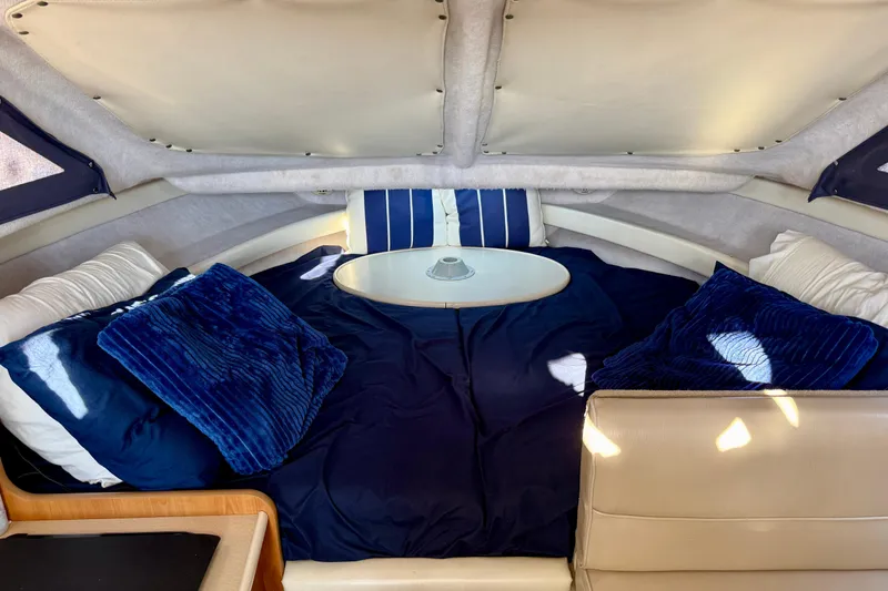 Slide: The Image of Interior cabin of 2002 Bayliner 2452 Ciera Classic with blue bedding and cushions. - 12
