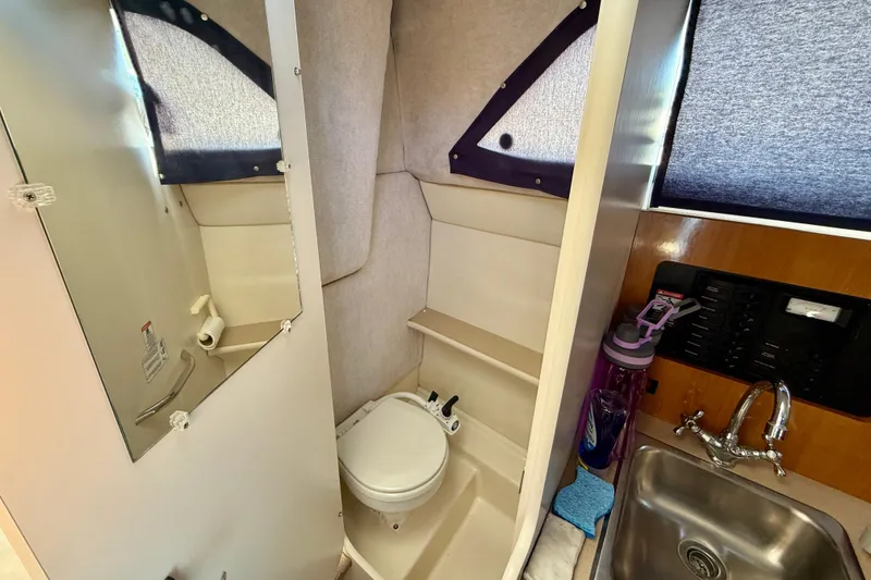 Slide: The Image of 2002 Bayliner 2452 Ciera Classic boat bathroom with toilet, sink, and mirror. - 13