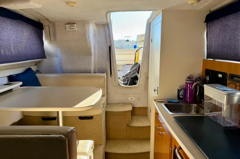 Slide: The Image of Interior of 2002 Bayliner 2452 Ciera Classic boat with kitchenette and dining area. - 14