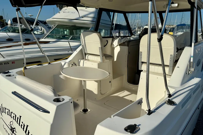 Slide: The Image of 2002 Bayliner 2452 Ciera Classic boat interior with seating and table in marina. - 5