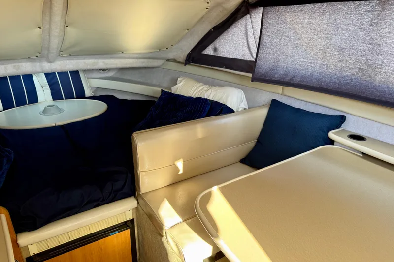 Slide: The Image of Interior of 2002 Bayliner 2452 Ciera Classic with seating, table, and cushions. - 9