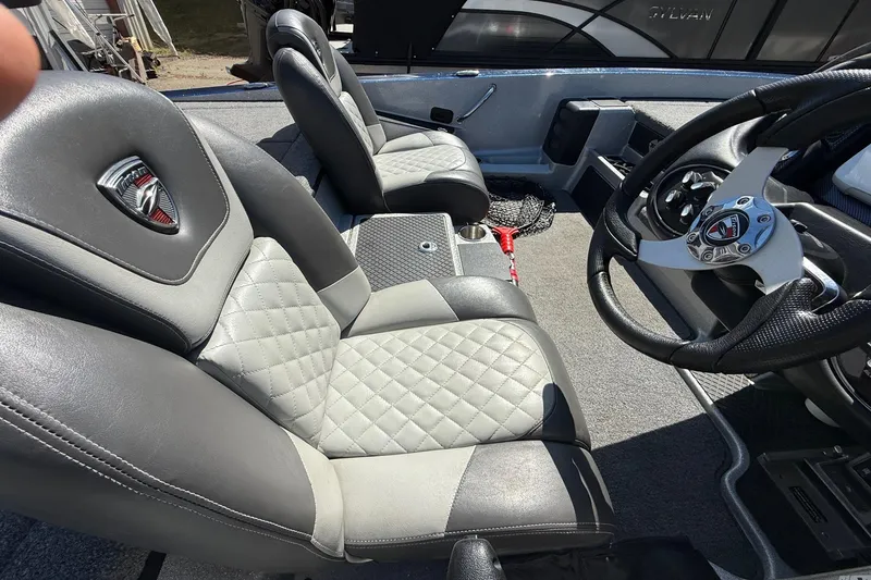 Slide: The Image of 2017 Triton 18 TrX boat interior with quilted seats and steering wheel detail. - 15
