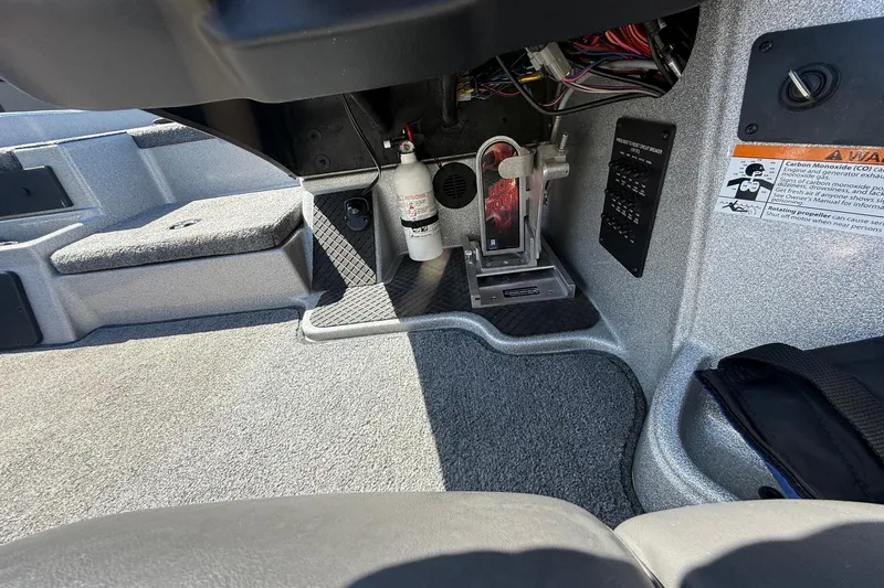 Slide: The Image of Interior of a 2017 Triton 18 TrX boat showing foot pedal and wiring. - 16