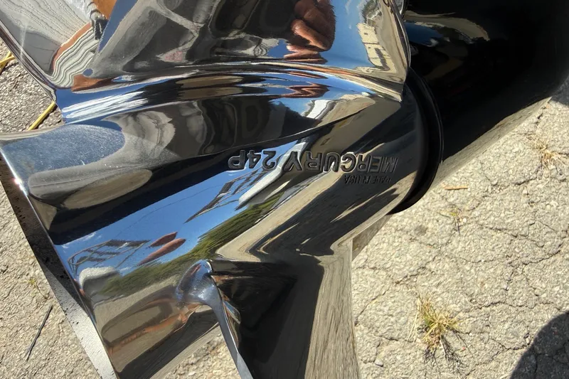 Slide: The Image of Shiny Mercury propeller on a 2017 Triton 18 TrX boat, reflecting surroundings. - 25