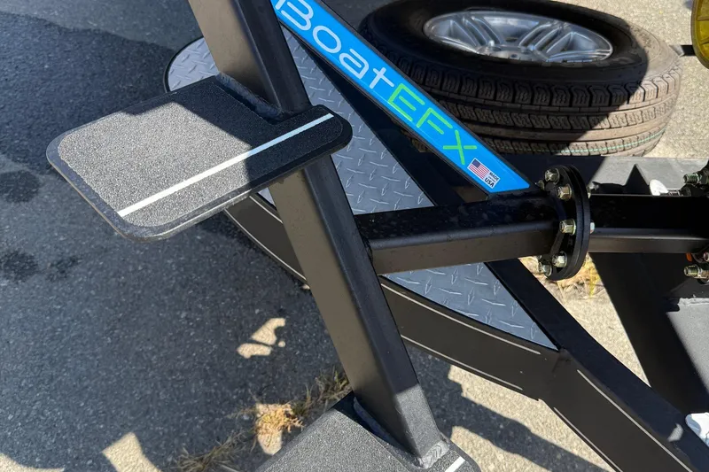 Slide: The Image of 2017 Triton 18 TrX trailer with BoatEFX step and spare tire. - 26