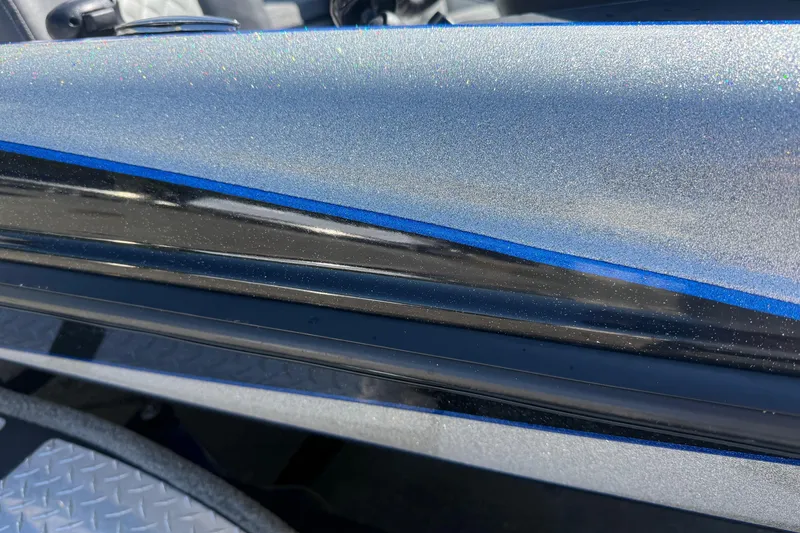 Slide: The Image of 2017 Triton 18 TrX boat with metallic blue and black detailing. - 9