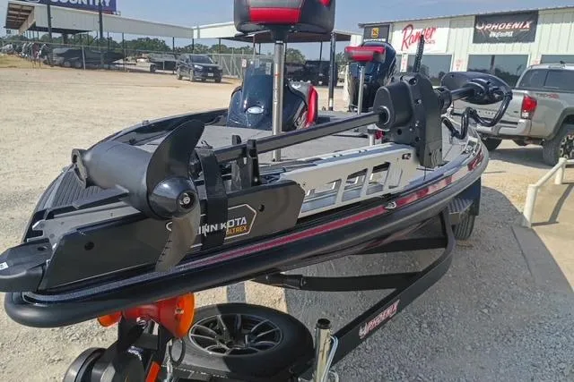 Slide: The Image of 2026 Phoenix 721 ZXL boat with Minn Kota trolling motor in a dealership lot. - 9