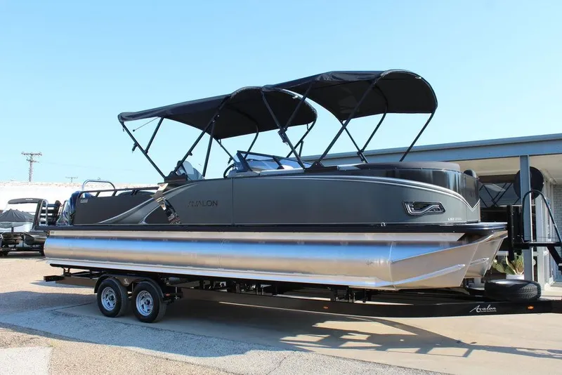 The Image of 2026 Avalon LSZ Versatile Rear Bench Windshield 27 FT pontoon boat on trailer. - 1