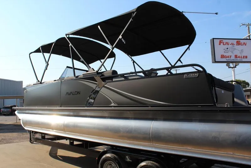 Slide: The Image of 2026 Avalon LSZ Versatile Rear Bench Windshield 27 FT pontoon boat at dealership. - 4