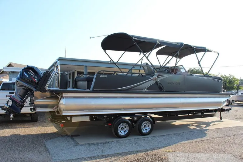 Slide: The Image of 2026 Avalon LSZ Versatile Rear Bench Windshield 27 FT pontoon boat on trailer. - 6