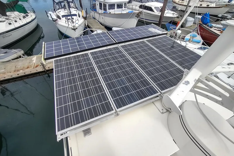 Slide: The Image of Solar panels on a 2004 Nordic Tug 32 boat docked at a marina. - 13