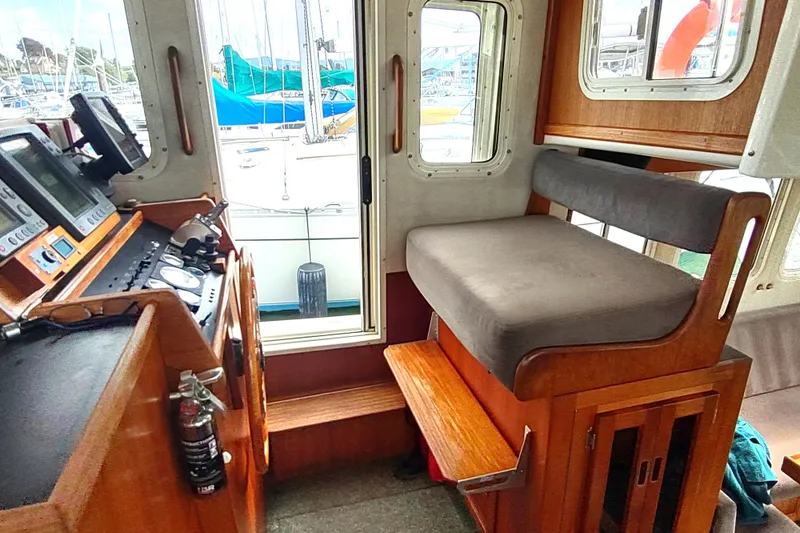 Slide: The Image of 2004 Nordic Tug 32 interior with navigation equipment and seating area. - 29
