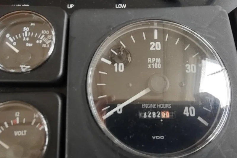 Slide: The Image of Close-up of Nordic Tug 32, 2004 dashboard gauges showing RPM and engine hours. - 32
