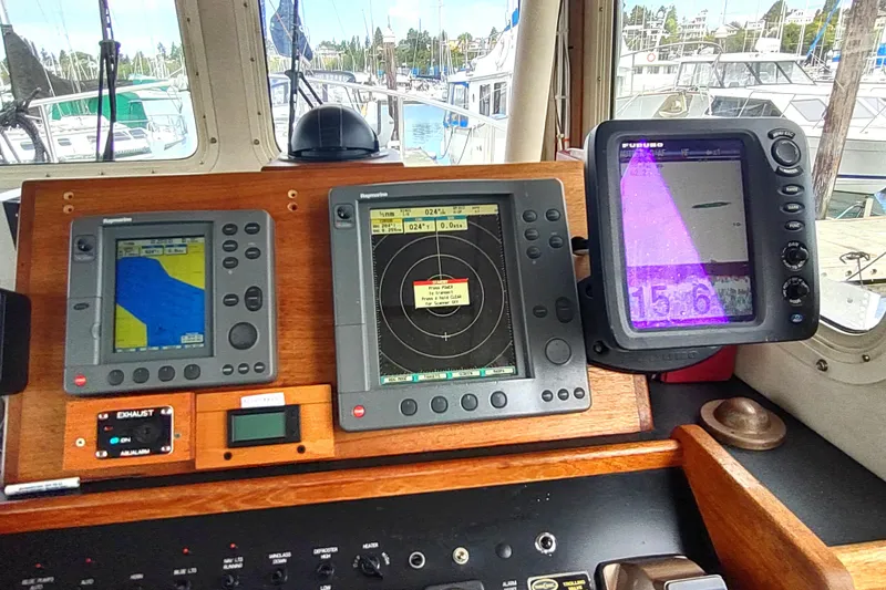 Slide: The Image of Pilothouse of 2004 Nordic Tug 32 with navigation and radar displays. - 33