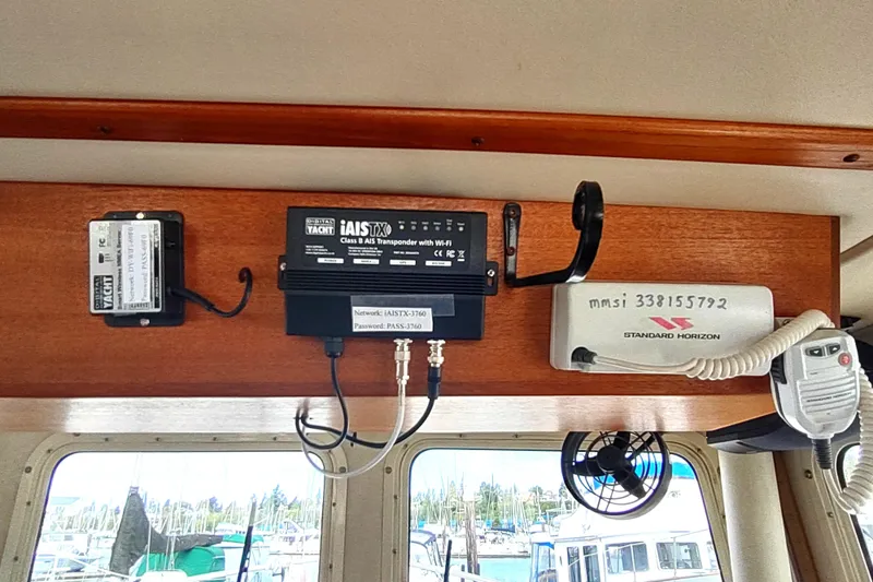 Slide: The Image of Navigation equipment inside a 2004 Nordic Tug 32 boat, featuring communication devices and transponder. - 36