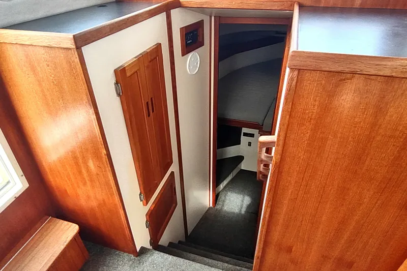 Slide: The Image of Interior view of 2004 Nordic Tug 32, featuring wooden cabinetry and carpeted stairs. - 37