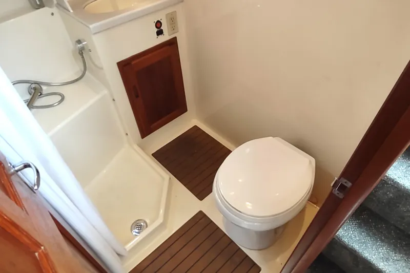 Slide: The Image of Bathroom interior of 2004 Nordic Tug 32, featuring toilet and shower area. - 38