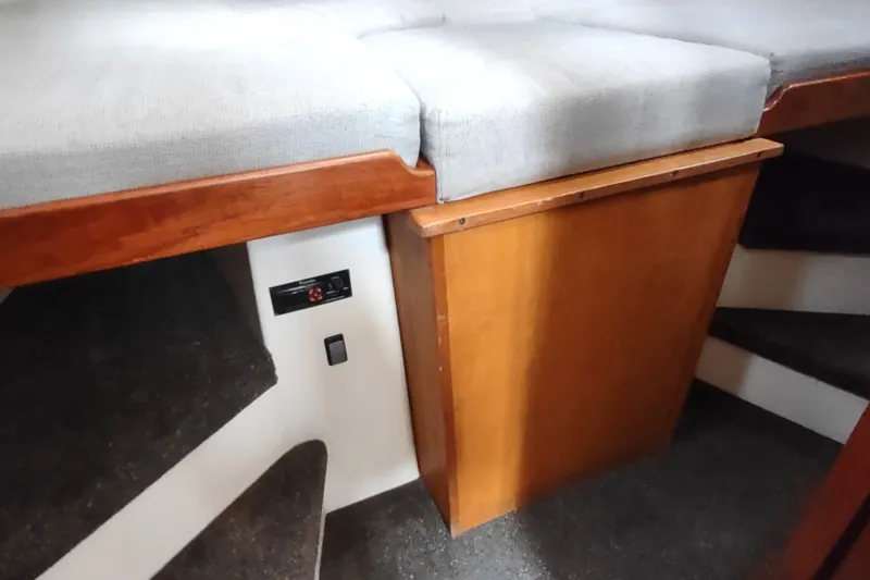 Slide: The Image of 2004 Nordic Tug 32 interior with wooden cabinetry and cushioned seating. - 40