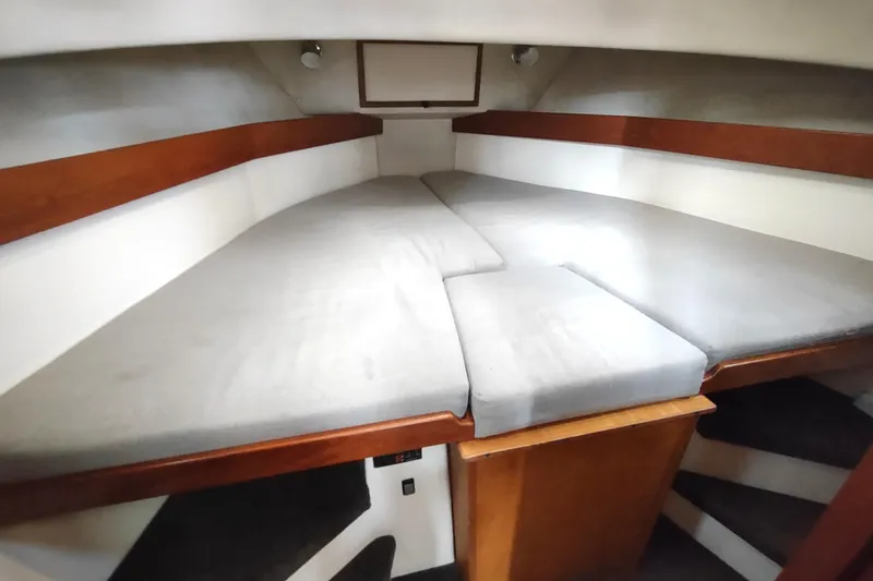 Slide: The Image of 2004 Nordic Tug 32 interior cabin with V-berth and wooden accents. - 41