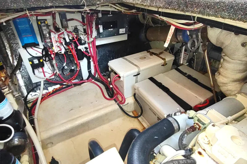 Slide: The Image of Engine room of a 2004 Nordic Tug 32, showcasing wiring and battery setup. - 49