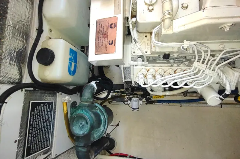 Slide: The Image of Engine room of a 2004 Nordic Tug 32, showcasing mechanical components and wiring. - 51