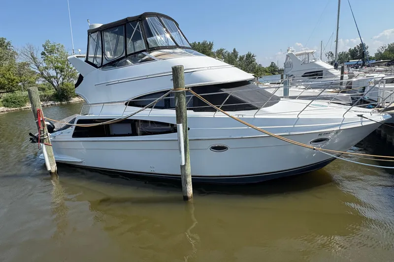 Slide: The Image of Cozy bedroom in 2003 Carver 360 Sport Sedan with colorful bedding and soft lighting. - 3