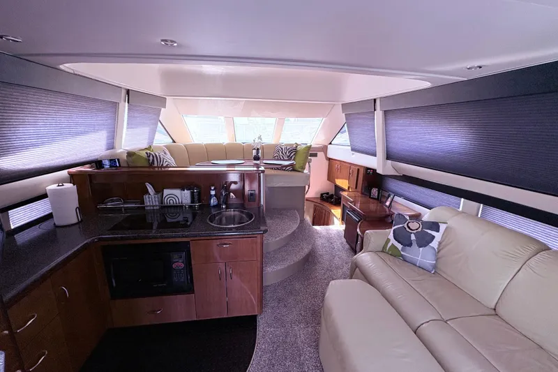 Slide: The Image of Interior of 2003 Carver 360 Sport Sedan with cozy seating and wooden cabinetry. - 8